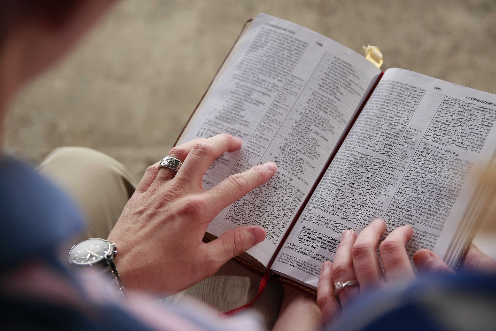 man-woman-hands-reading-bible